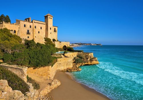 Cala La Jovera beach under Tamarit castle in Tarragona of Catalonia
